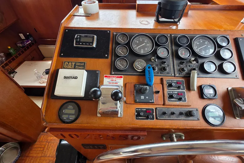 Slide: The Image of 1991 Marine Trader Trawler helm with gauges, controls, and CAT Diesel Power panel. - 20