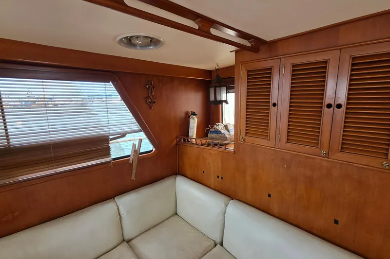 Slide: The Image of Interior of 1991 Marine Trader Trawler with wooden cabinets and white seating. - 21