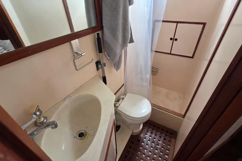 Slide: The Image of Bathroom interior of a 1991 Marine Trader Trawler with sink, toilet, and shower. - 22
