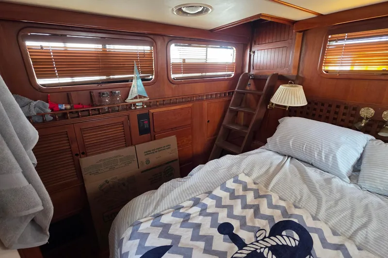 Slide: The Image of Cozy cabin interior of 1991 Marine Trader Trawler with nautical decor and wooden accents. - 23