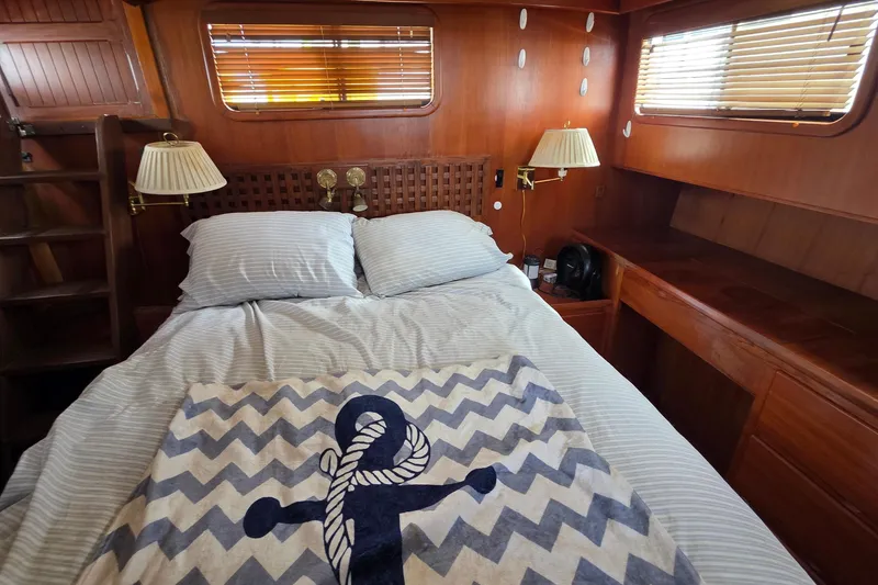 Slide: The Image of Cozy bedroom in 1991 Marine Trader Trawler with nautical-themed decor and wooden interior. - 24