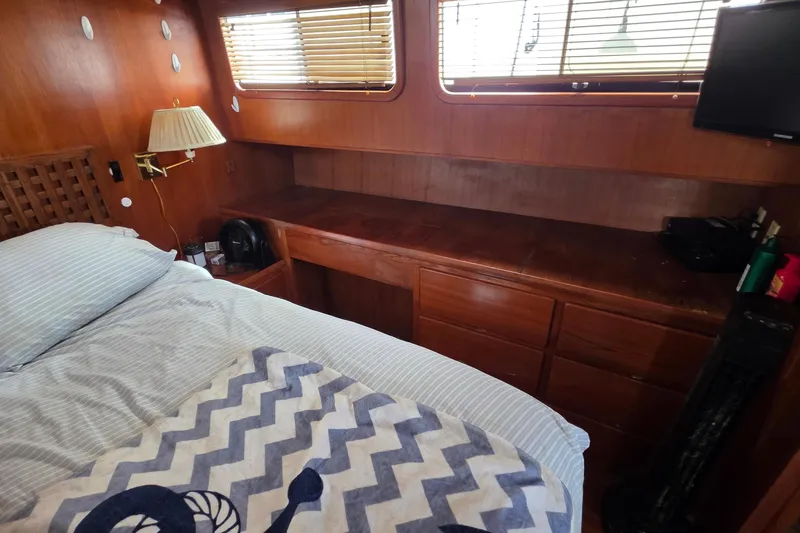 Slide: The Image of Cozy cabin interior of 1991 Marine Trader Trawler with wooden furnishings and bed. - 25