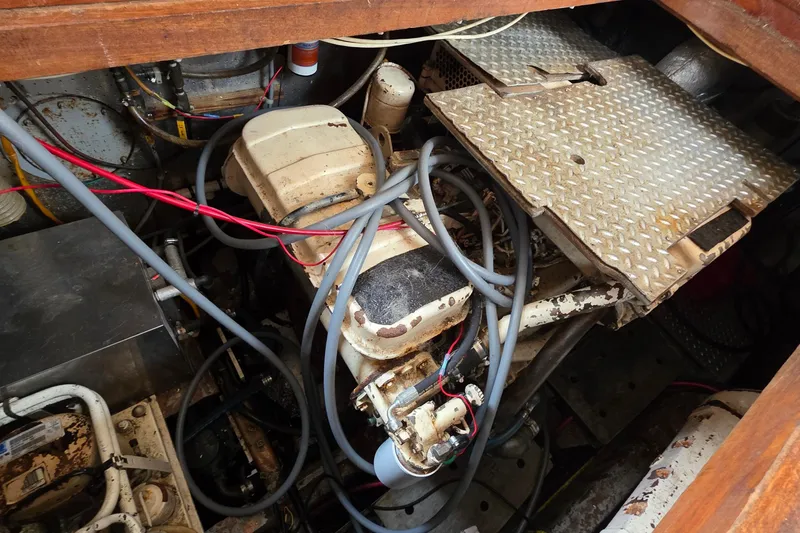 Slide: The Image of Engine room of a 1991 Marine Trader Trawler with visible wiring and machinery. - 27