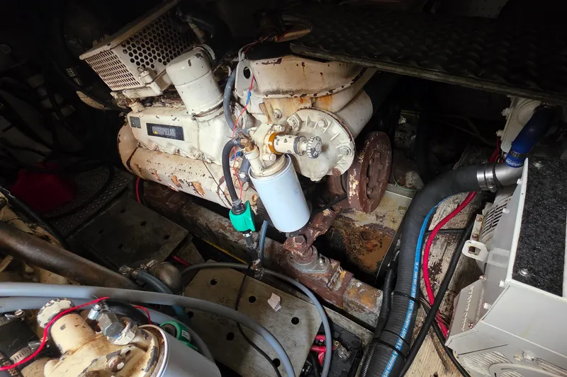 Slide: The Image of Engine room of a 1991 Marine Trader Trawler with visible machinery and components. - 28