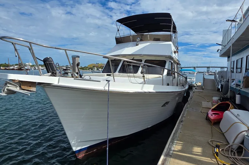 Slide: The Image of 1991 Marine Trader Trawler docked at marina under blue sky. - 3