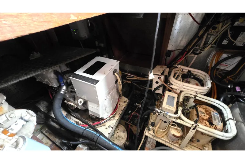 Slide: The Image of Engine room of a 1991 Marine Trader Trawler with visible machinery and wiring. - 30