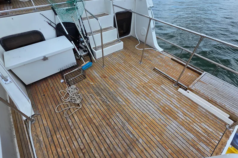Slide: The Image of 1991 Marine Trader Trawler deck with fishing gear and wooden flooring. - 31