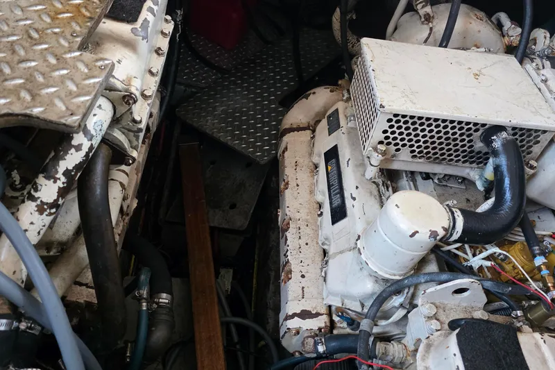 Slide: The Image of Engine room of a 1991 Marine Trader Trawler with visible machinery and components. - 35