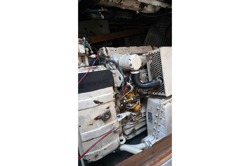 Slide: The Image of Engine compartment of a 1991 Marine Trader Trawler, showcasing mechanical components and wiring. - 36