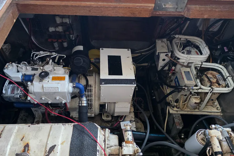 Slide: The Image of Engine room of a 1991 Marine Trader Trawler, showcasing mechanical components and wiring. - 37