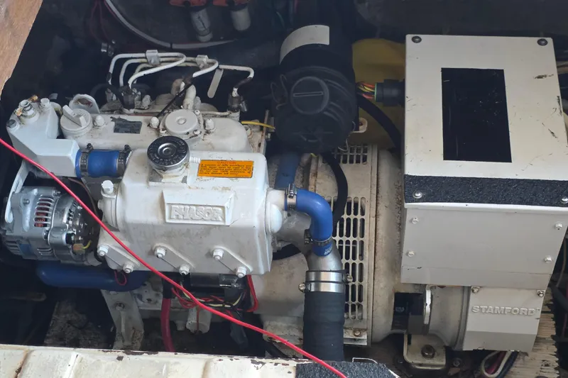 Slide: The Image of Engine compartment of a 1991 Marine Trader Trawler, featuring a detailed view of the machinery. - 40