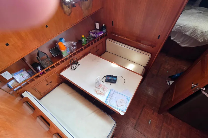 Slide: The Image of Interior of a 1991 Marine Trader Trawler with wooden cabinetry and dining area. - 5