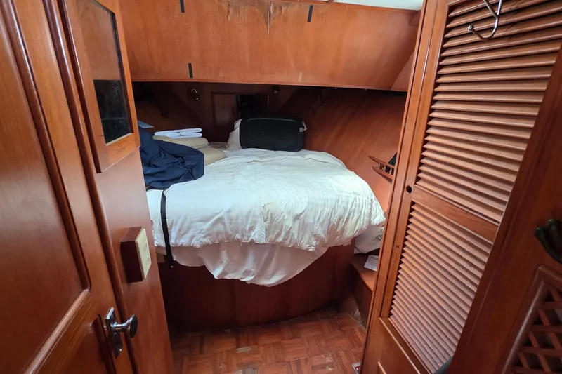 Slide: The Image of Cozy cabin interior of a 1991 Marine Trader Trawler with wooden furnishings and a comfortable bed. - 7