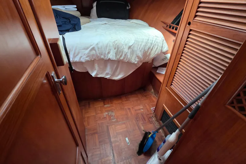 Slide: The Image of Cozy cabin interior of a 1991 Marine Trader Trawler with wooden furnishings and a bed. - 9