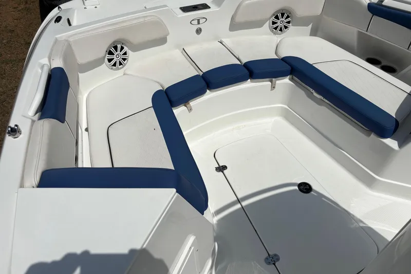 Slide: The Image of 2020 Tahoe 2150 CC boat interior with blue and white seating and speakers. - 11
