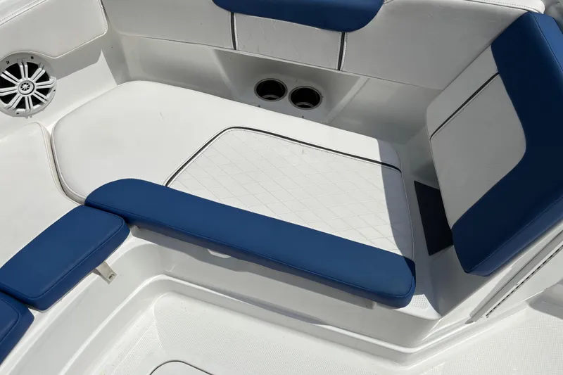Slide: The Image of 2020 Tahoe 2150 CC boat interior with blue and white cushioned seating. - 12