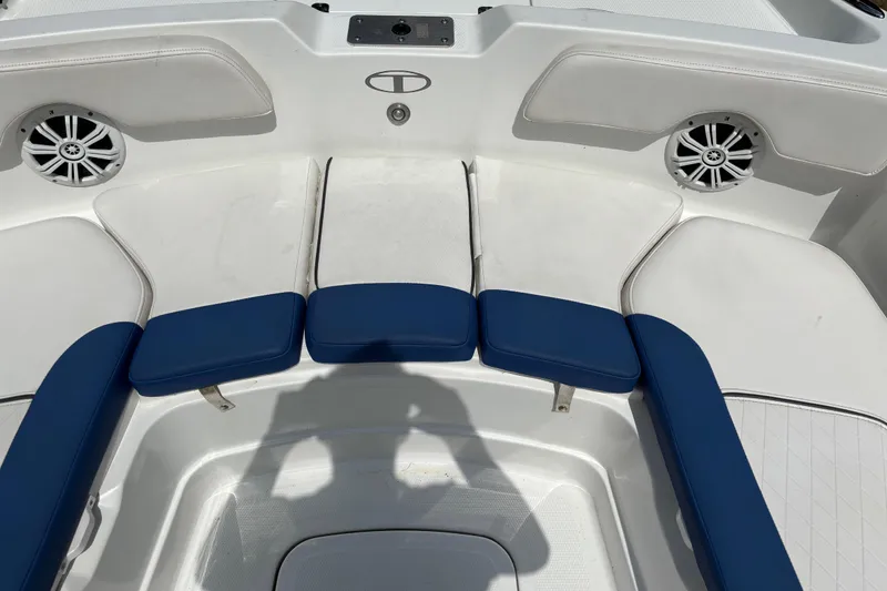 Slide: The Image of 2020 Tahoe 2150 CC boat interior with blue and white seating and speakers. - 13