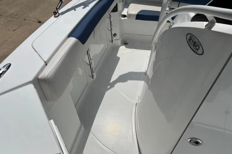 Slide: The Image of 2020 Tahoe 2150 CC boat interior with white and blue seating. - 16