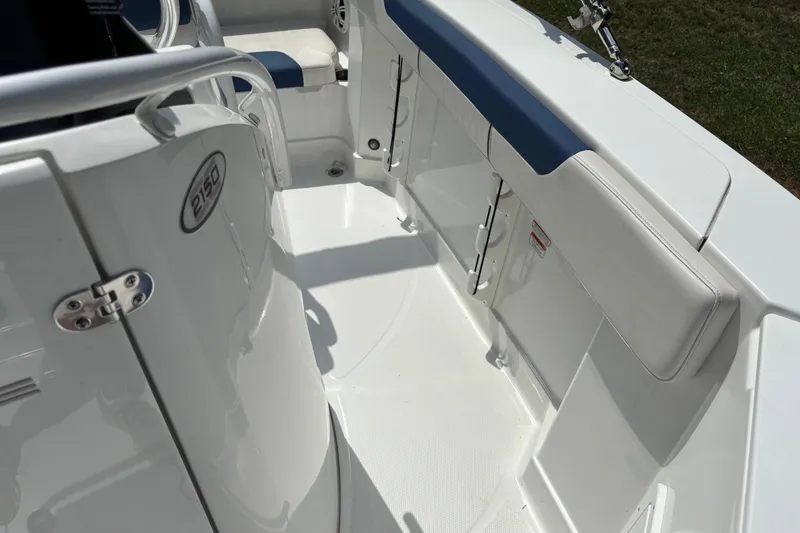 Slide: The Image of 2020 Tahoe 2150 CC boat interior with white seating and blue accents. - 17