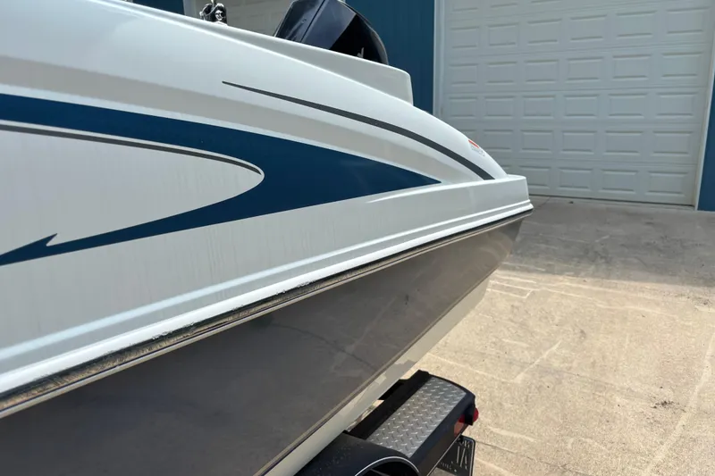 Slide: The Image of 2020 Tahoe 2150 CC boat side view with sleek blue and white design. - 26