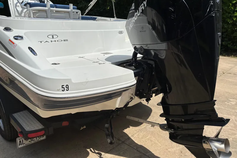 Slide: The Image of 2020 Tahoe 2150 CC boat with Mercury outboard motor on a trailer. - 3