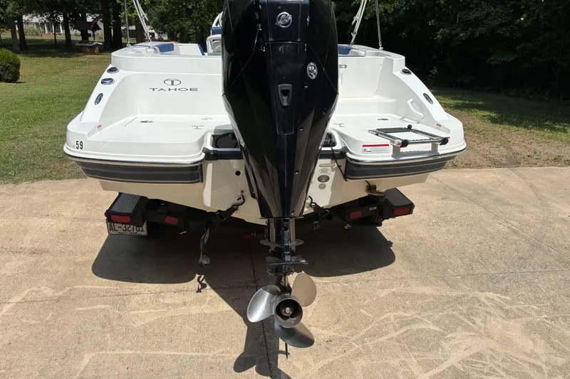 Slide: The Image of Rear view of a 2020 Tahoe 2150 CC boat with outboard motor on a driveway. - 4