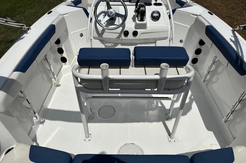 Slide: The Image of 2020 Tahoe 2150 CC boat interior with blue and white seating and steering console. - 8