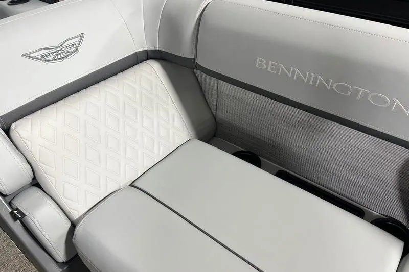 Slide: The Image of 2026 Bennington 22 M Swingback boat interior with elegant gray seating and logo detailing. - 12