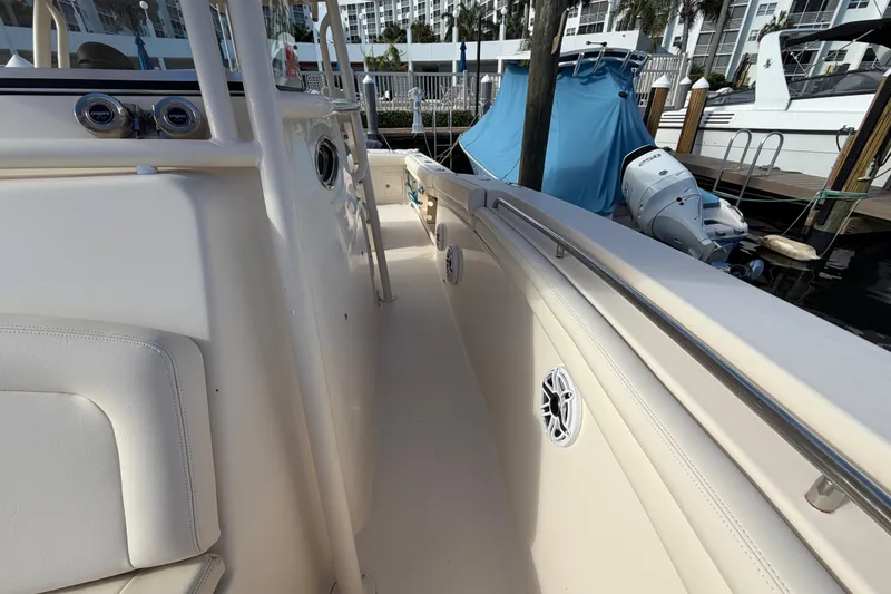 Slide: The Image of 2016 Grady-White Canyon 336 boat interior with seating and docked engine view. - 10