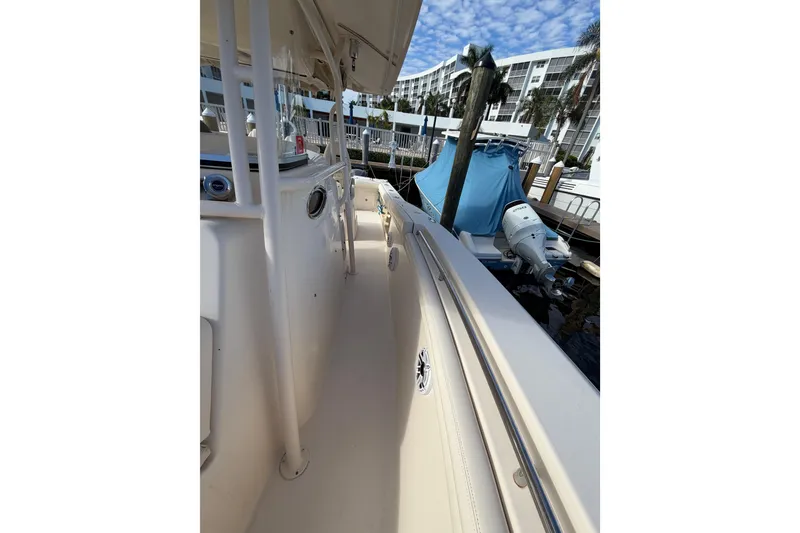 Slide: The Image of 2016 Grady-White Canyon 336 boat docked, showcasing sleek design and outboard motor. - 11