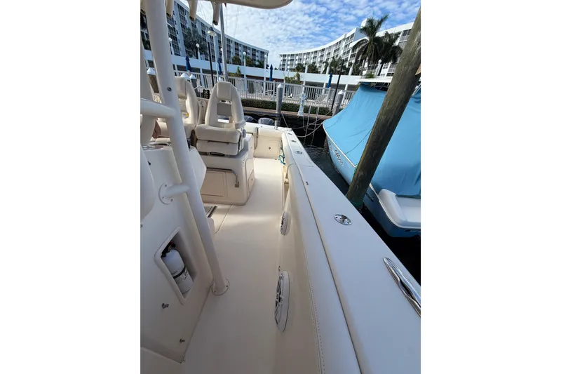 Slide: The Image of 2016 Grady-White Canyon 336 boat interior, docked with modern seating and clear skies. - 12