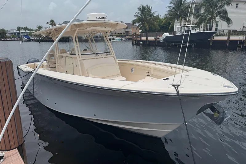 Slide: The Image of 2016 Grady-White Canyon 336 boat docked in a serene marina setting. - 15