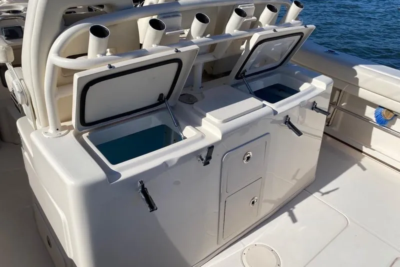 Slide: The Image of 2016 Grady-White Canyon 336 boat with open storage compartments and rod holders. - 16