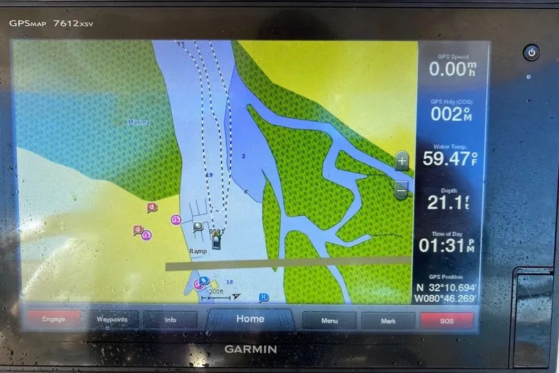 Slide: The Image of Garmin GPS display on a 2016 Grady-White Canyon 336, showing navigation and water data. - 21