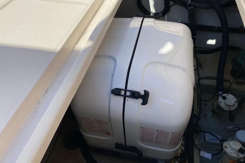 Slide: The Image of 2016 Grady-White Canyon 336 boat engine compartment with secured white cover. - 22