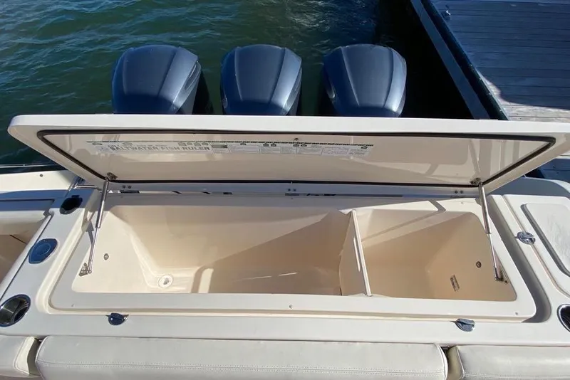 Slide: The Image of Open storage compartment on a 2016 Grady-White Canyon 336 boat, docked by the water. - 23