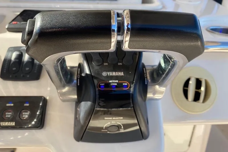 Slide: The Image of Throttle controls on a 2016 Grady-White Canyon 336 boat, featuring Yamaha engine controls. - 24