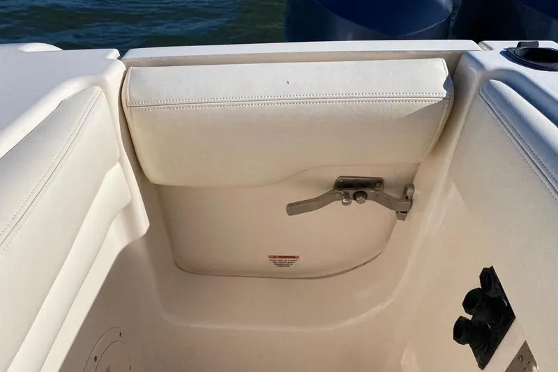 Slide: The Image of Interior view of a 2016 Grady-White Canyon 336 boat, featuring a cushioned seat and latch. - 27