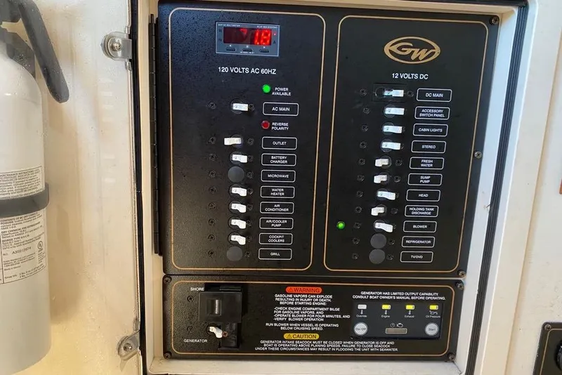 Slide: The Image of Electrical panel of a 2016 Grady-White Canyon 336 boat with fire extinguisher. - 28