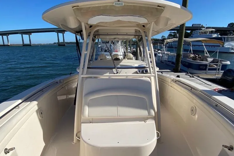 Slide: The Image of 2016 Grady-White Canyon 336 boat docked, showcasing spacious deck and seating area. - 29