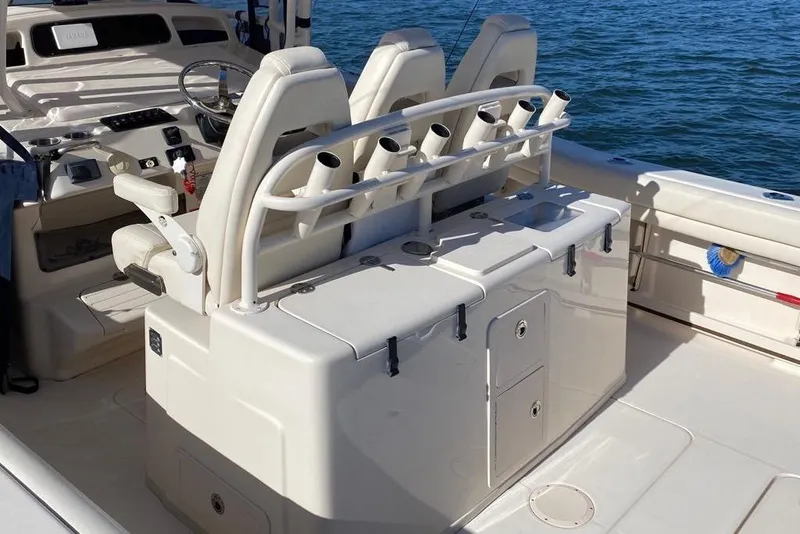 Slide: The Image of 2016 Grady-White Canyon 336 boat interior with seating and rod holders on the water. - 30