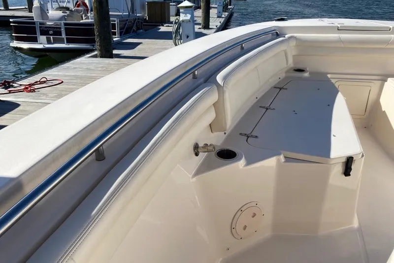 Slide: The Image of 2016 Grady-White Canyon 336 boat interior with seating and storage at dock. - 33