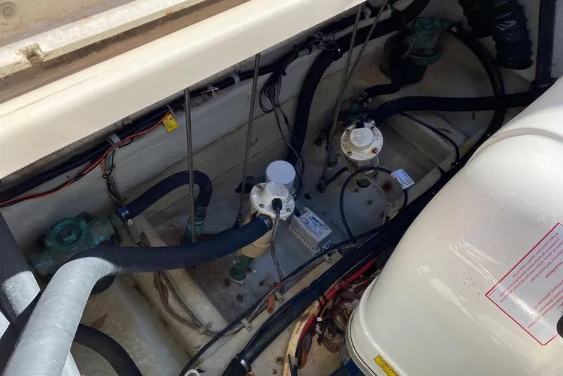 Slide: The Image of Engine compartment of a 2016 Grady-White Canyon 336 boat, showing hoses and components. - 34