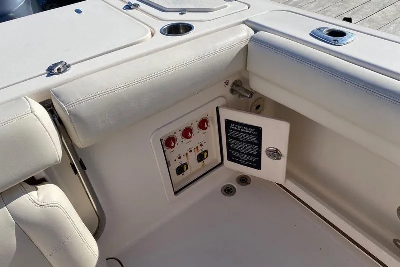 Slide: The Image of Battery compartment of a 2016 Grady-White Canyon 336 boat with control switches. - 35