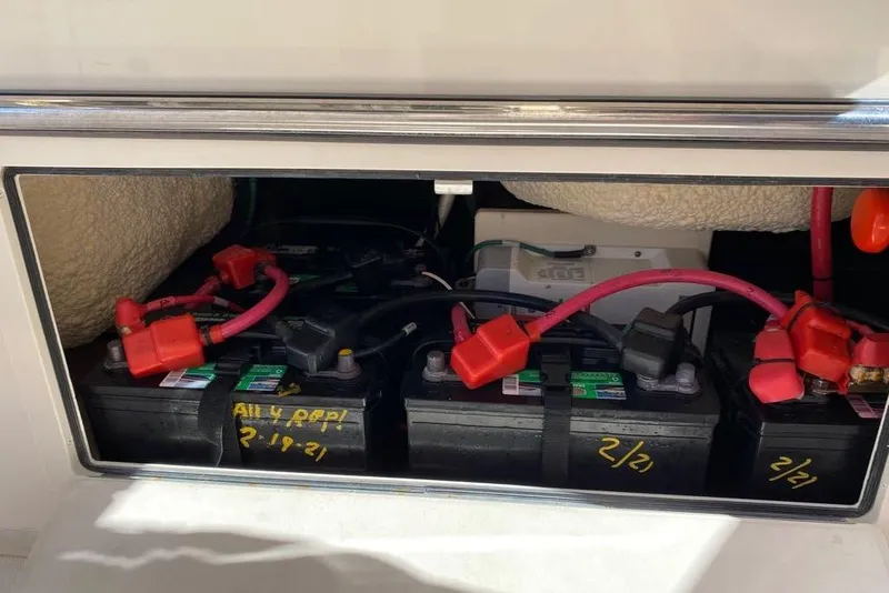 Slide: The Image of Battery compartment of 2016 Grady-White Canyon 336 boat with red cables. - 36
