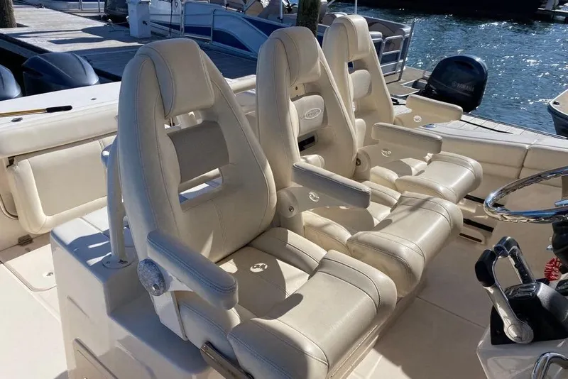 Slide: The Image of 2016 Grady-White Canyon 336 boat with luxurious white seating and steering wheel. - 39