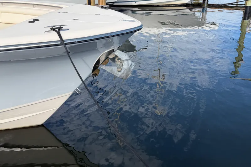 Slide: The Image of 2016 Grady-White Canyon 336 boat docked, showing bow and anchor in calm water. - 7