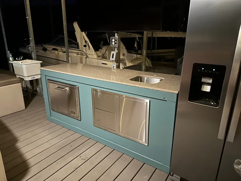 Slide: The Image of Carver 36 Mariner 2012 with modern outdoor kitchen and stainless steel appliances. - 19