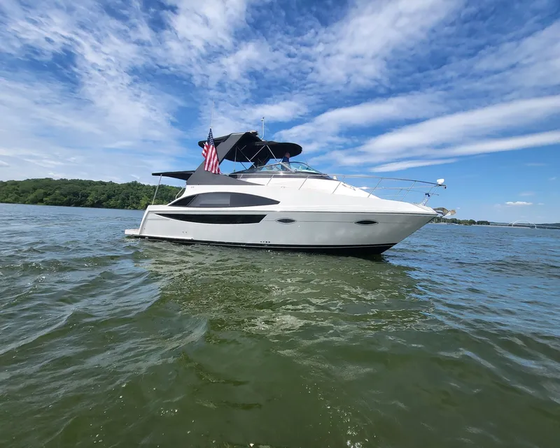 Slide: The Image of 2012 Carver 36 Mariner yacht on open water under clear skies. - 2