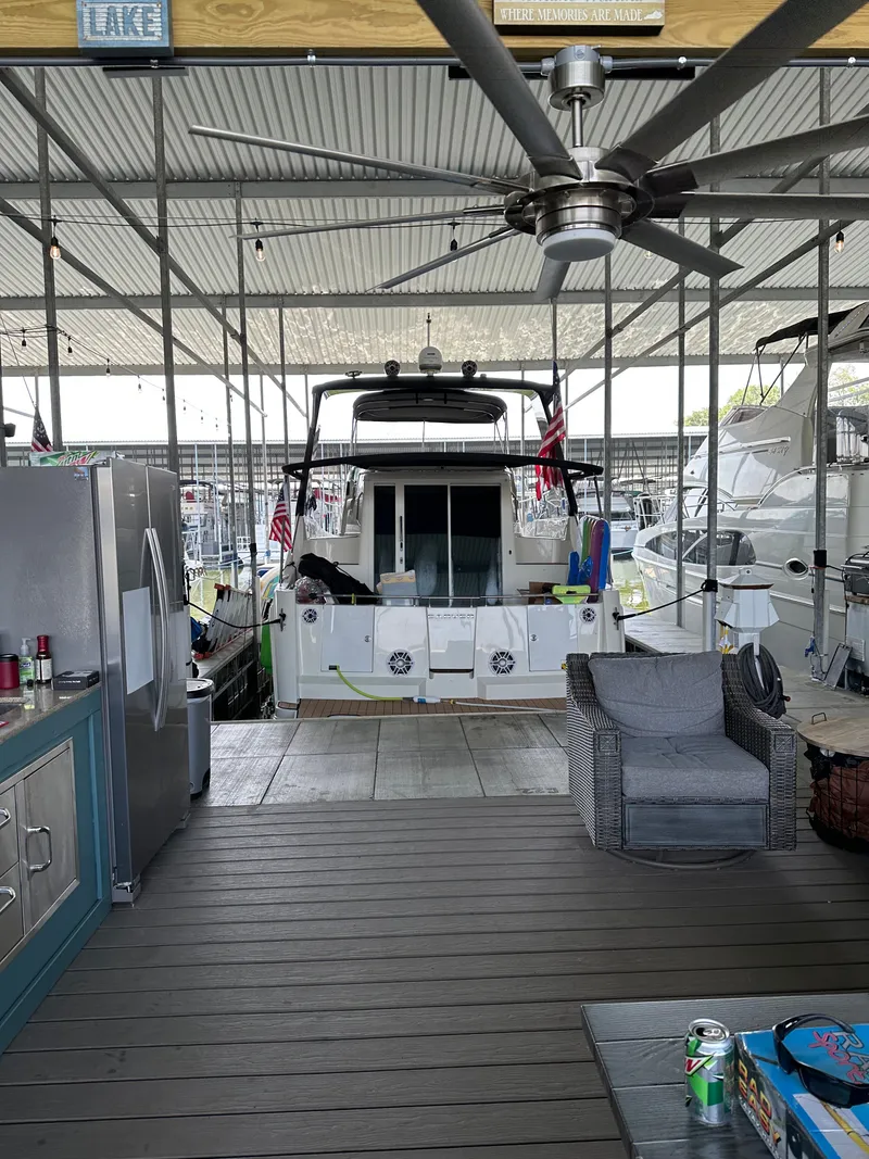 Slide: The Image of Carver 36 Mariner 2012 in covered dock with patio and ceiling fan. - 23